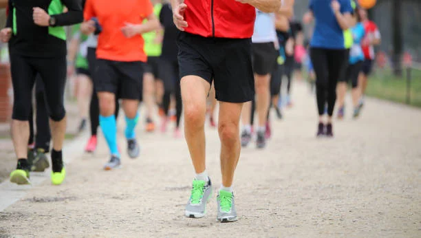 Legs Of Many Runners At Footrace In The City